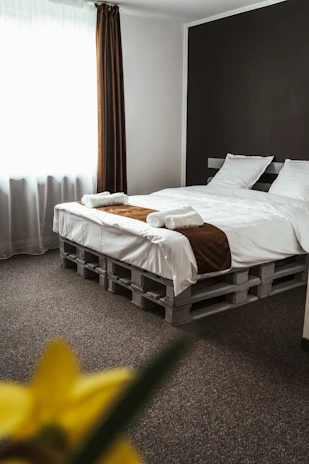a bedroom with a bed made out of pallets