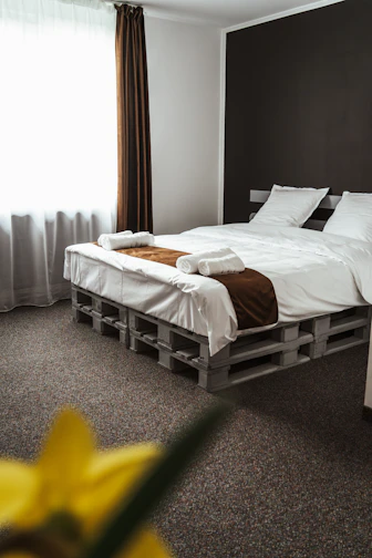 a bedroom with a bed made out of pallets
