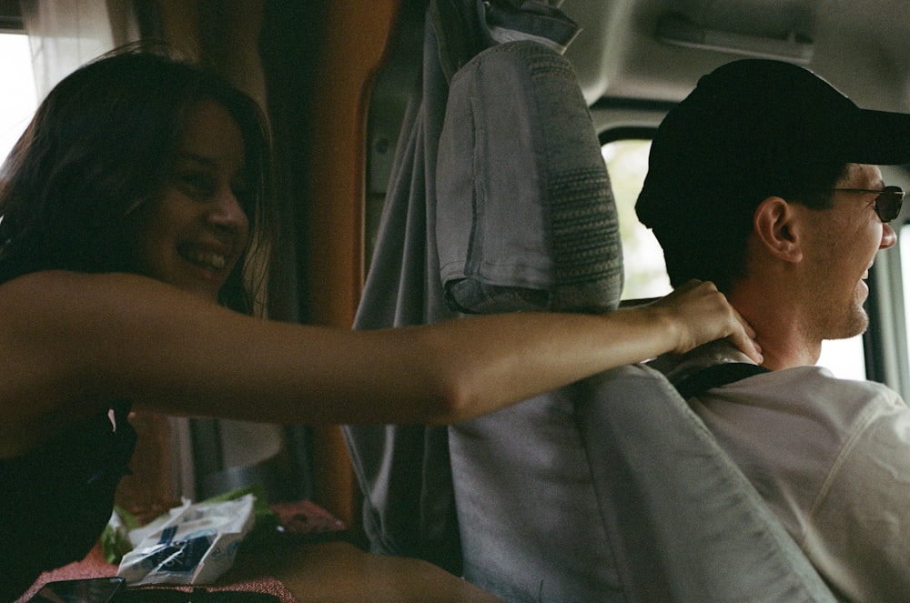 a woman helping a man put on a tie