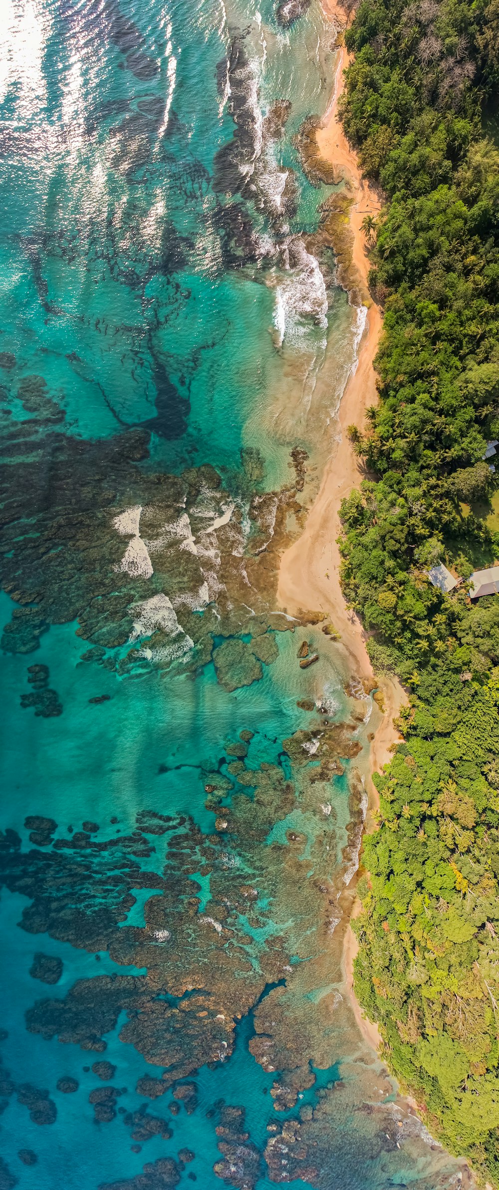 an aerial view of the ocean and a sandy beach