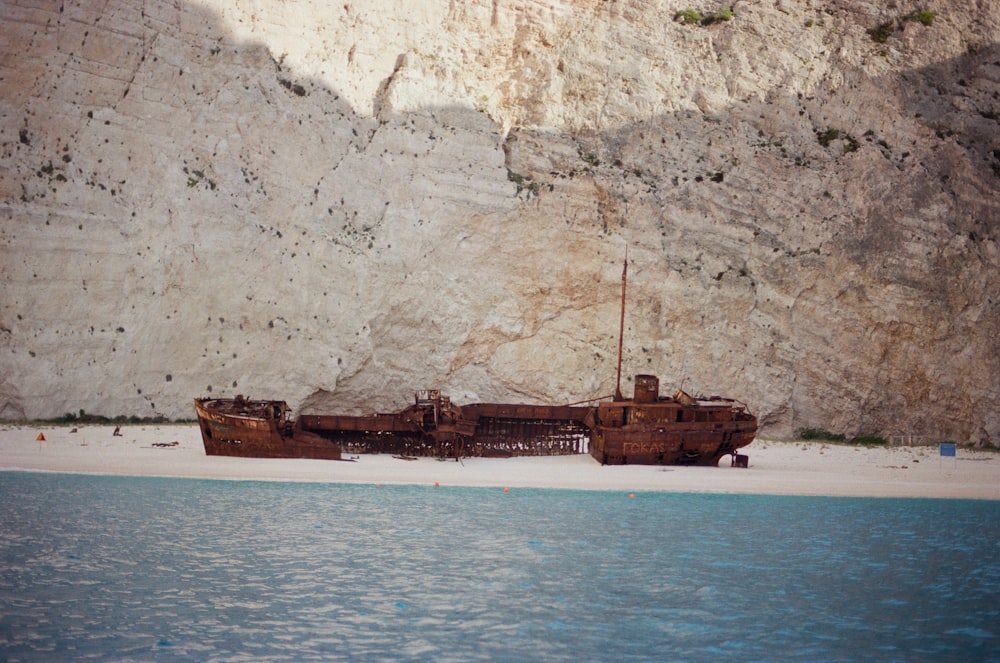 a boat sitting on top of a sandy beach