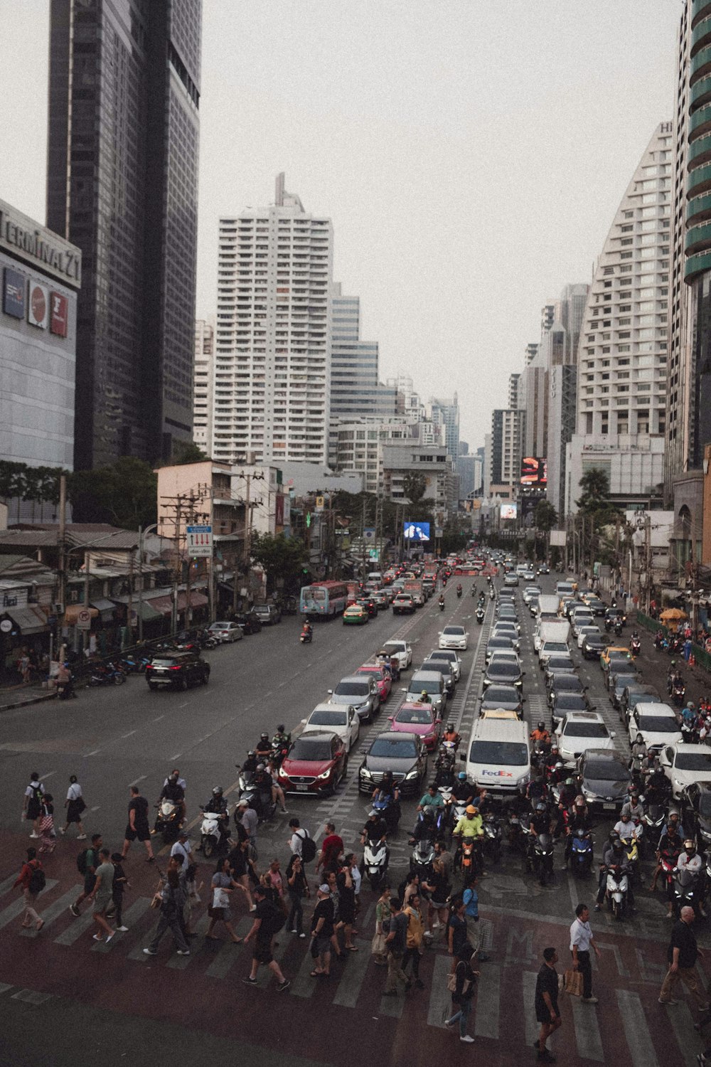 a large group of people crossing a busy street