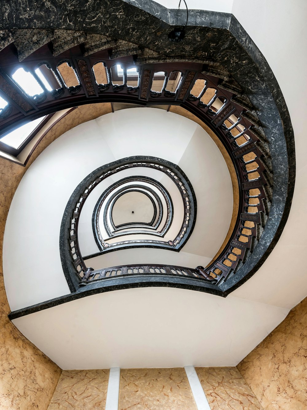 a spiral staircase in a building with a skylight