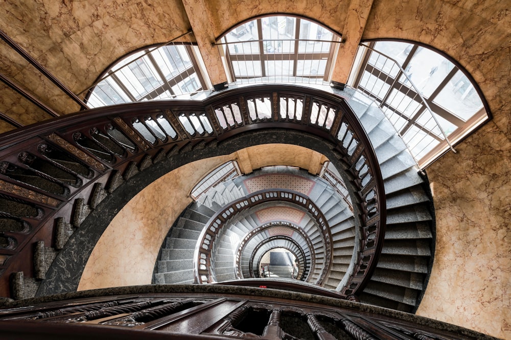 a spiral staircase in a building with a skylight