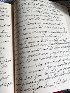 a close up of an open book with writing on it