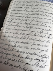 a book with writing on it sitting on a table