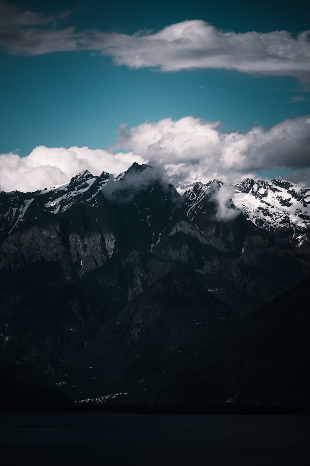 a view of a mountain range with clouds in the sky