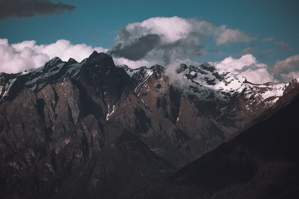 a view of a mountain range with clouds in the sky