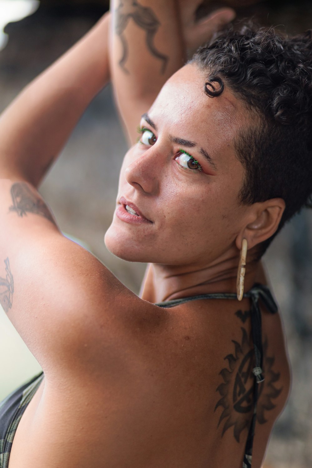 a woman with a tattoo on her chest posing for a picture