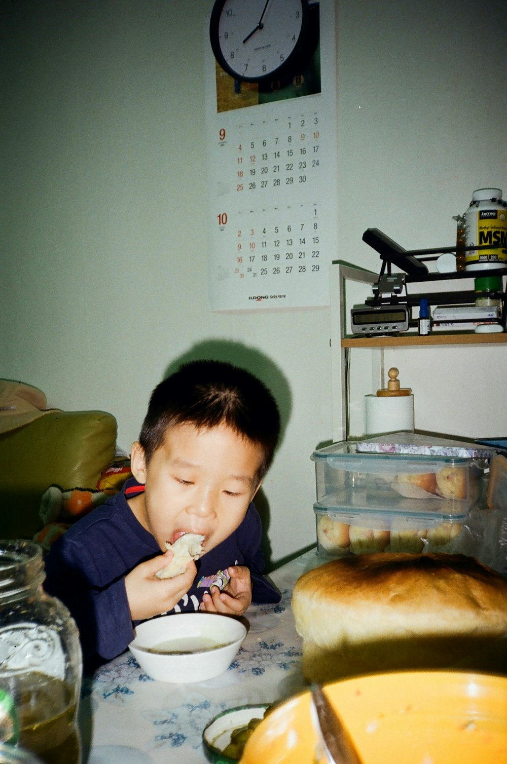 a young boy eating a bowl of food