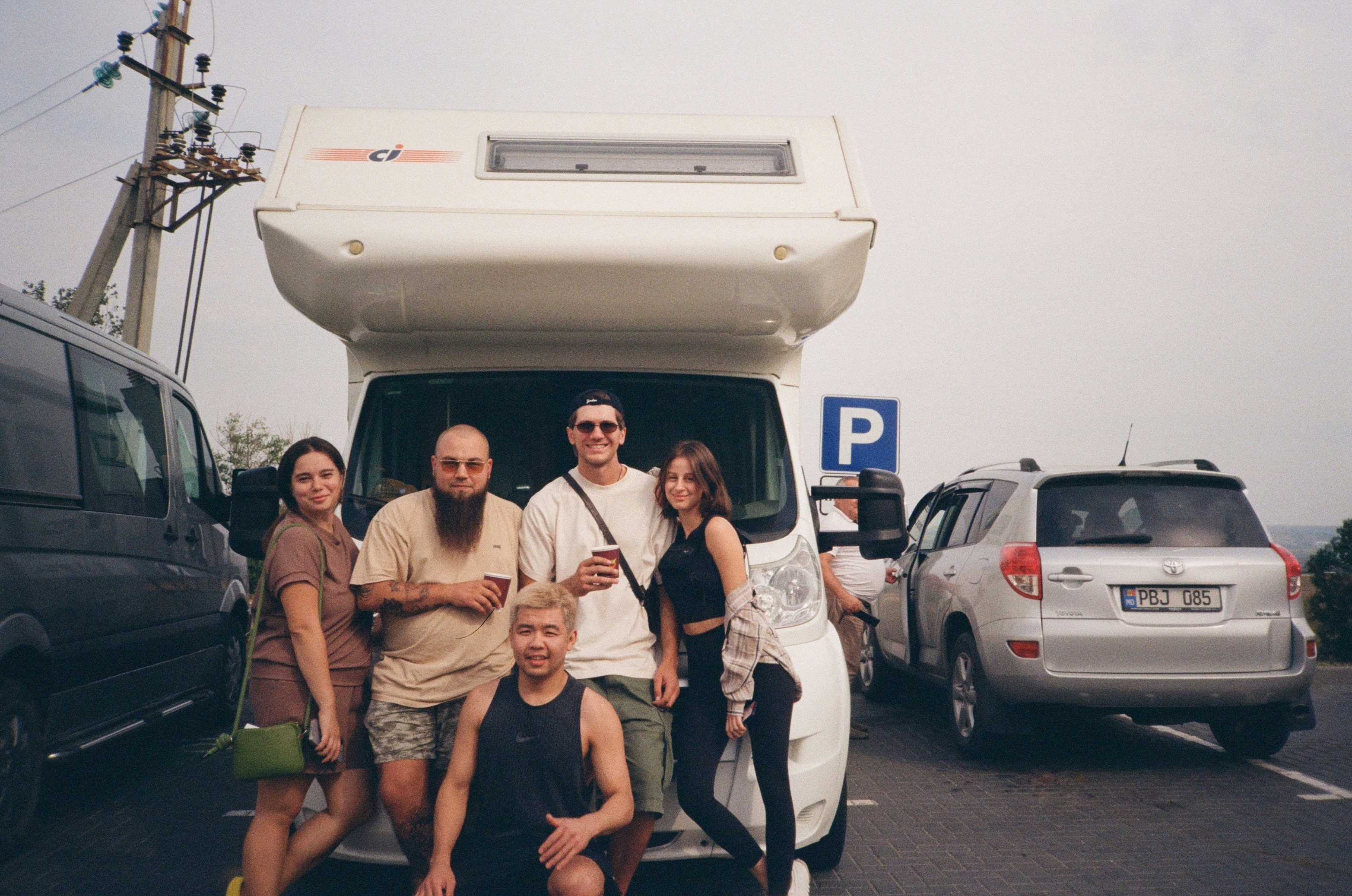 a group of people standing in front of a van