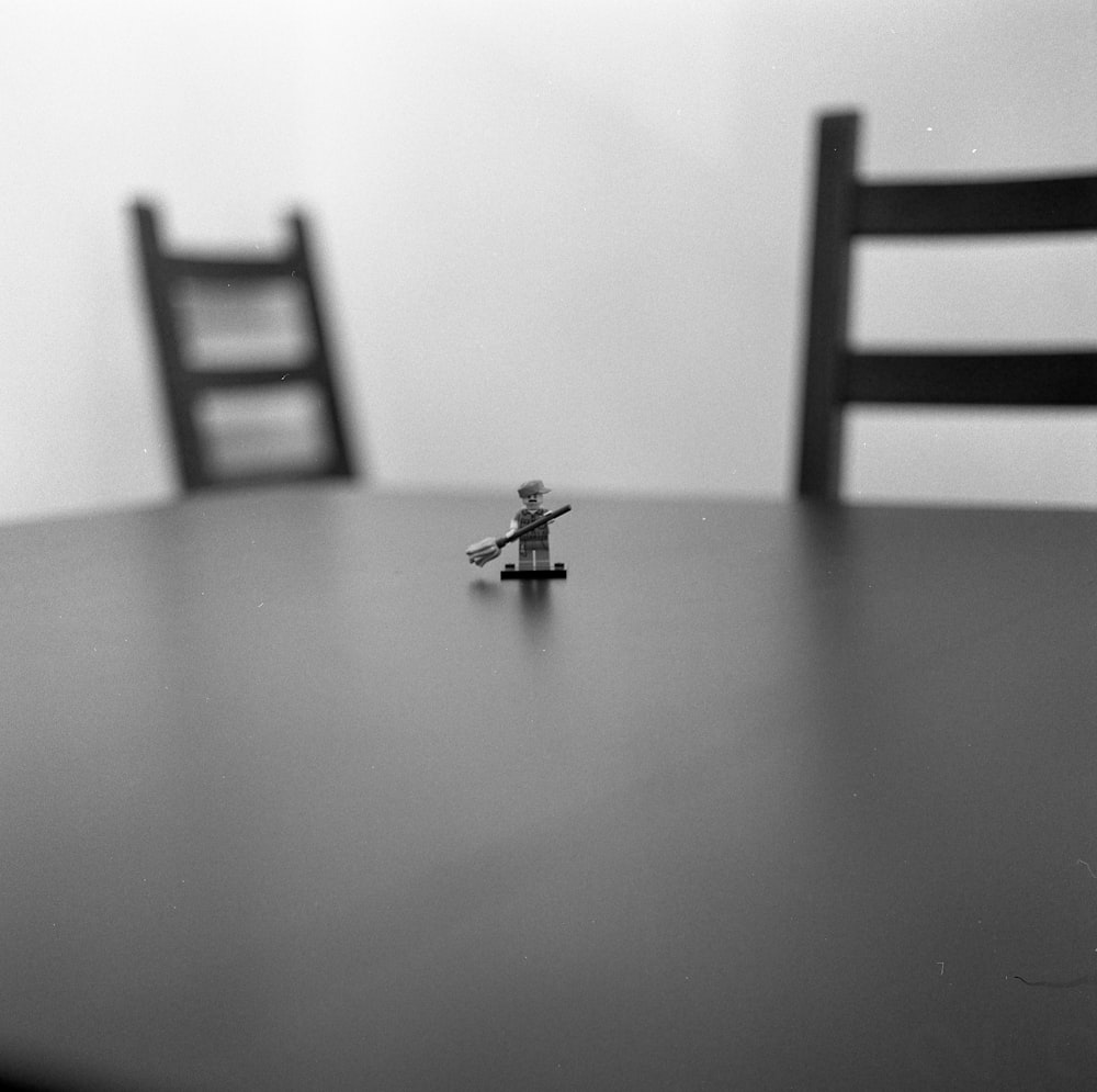 a small toy sitting on top of a wooden table