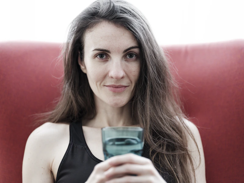 Woman sitting on a red chair with a phone
