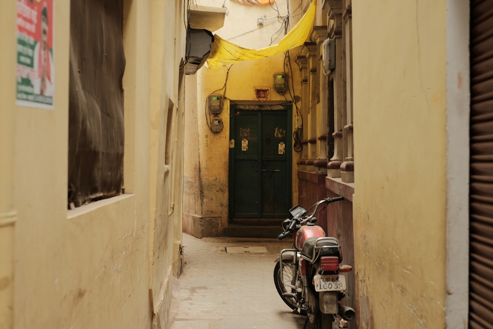 a motorcycle is parked in a narrow alley