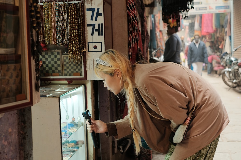 a woman looking at jewelry in a store