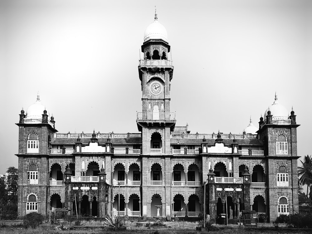 a black and white photo of a building with a clock tower