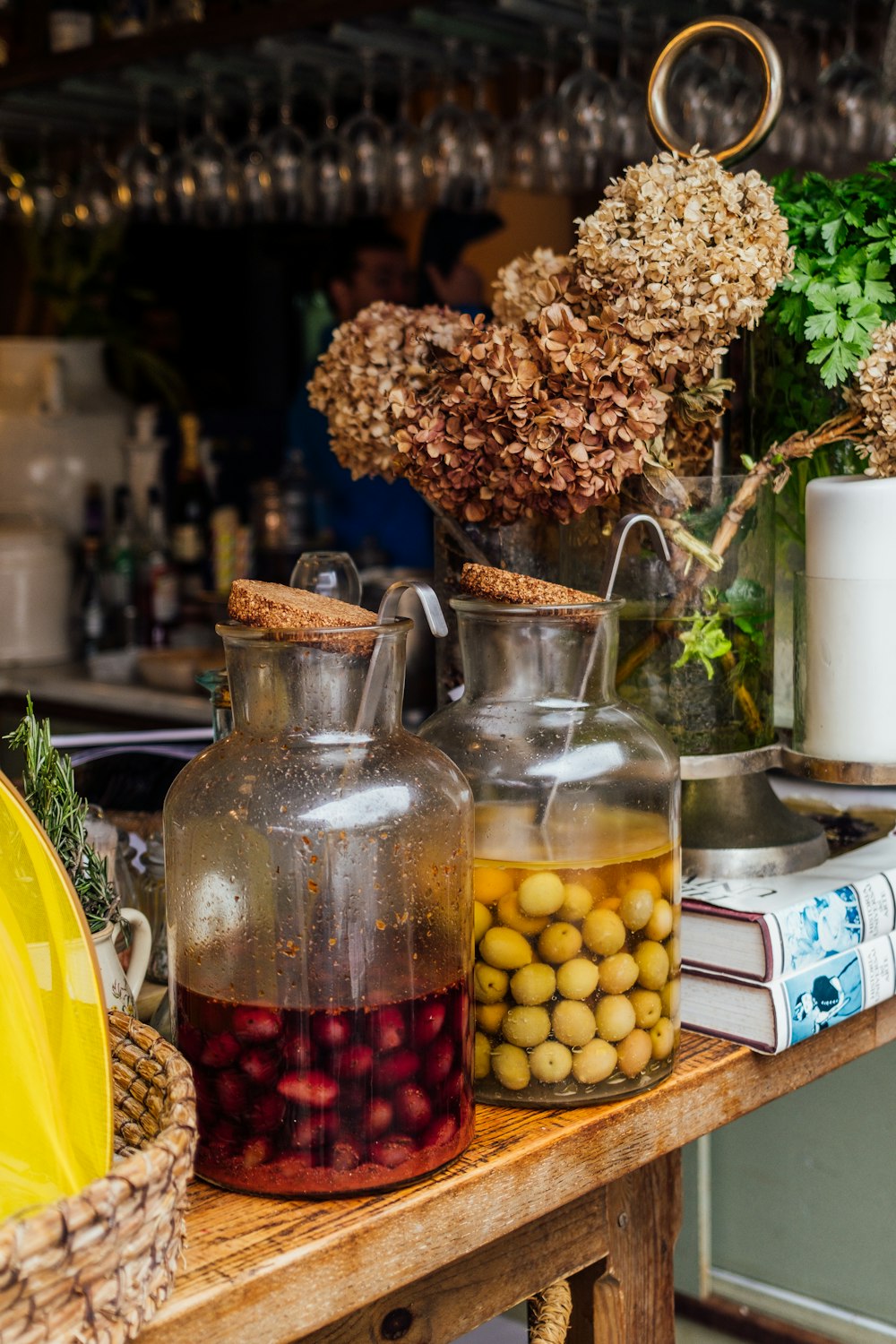 a wooden table topped with jars filled with food