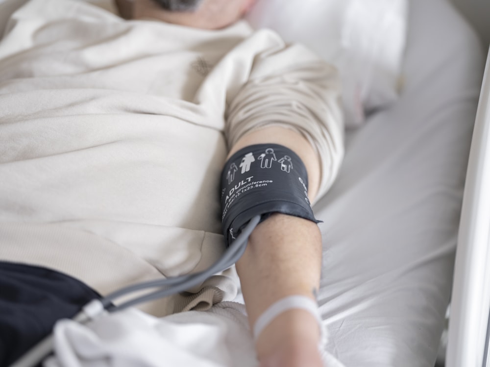 a man laying in a bed with a cast on his arm