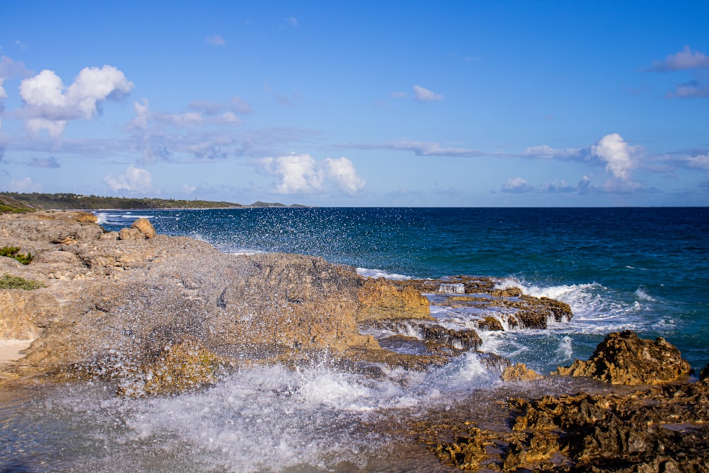 a view of the ocean from a rocky shore