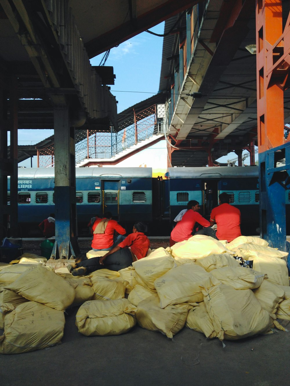 a bunch of bags of sand next to a train