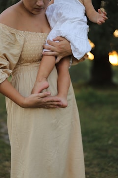 a woman holding a baby in her arms