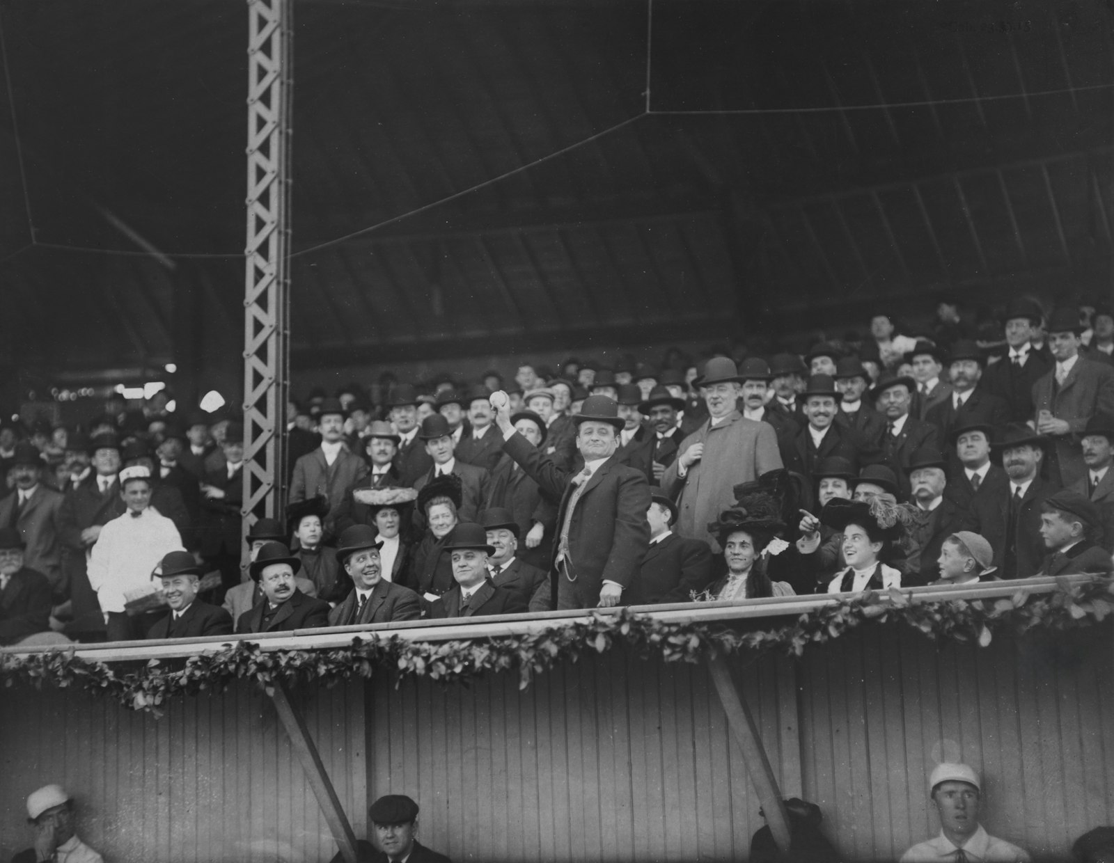 Archival photograph of a large crowd filling a stadium in the early twentieth century