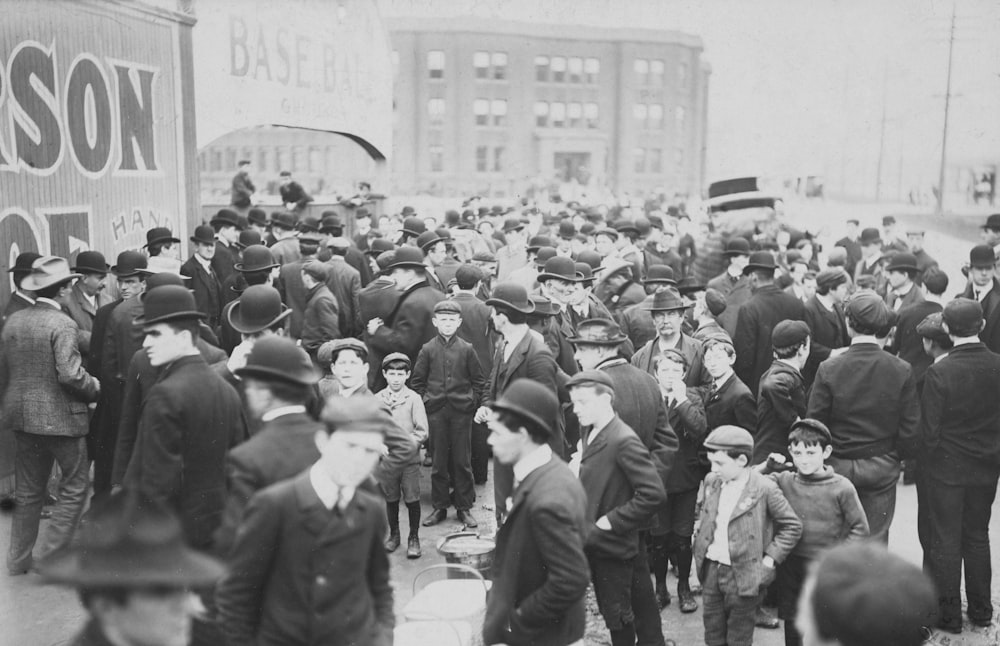 a crowd of people walking down a street