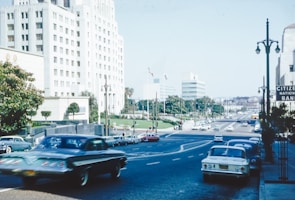 a street filled with lots of traffic next to tall buildings