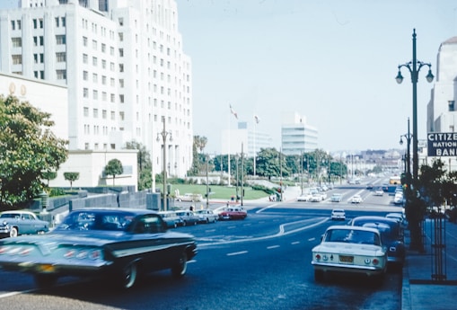 a street filled with lots of traffic next to tall buildings