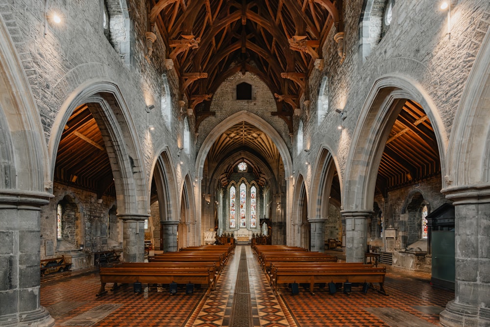 a large cathedral with pews and a checkered floor