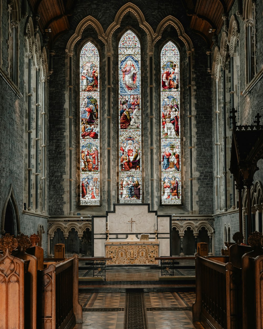 a church with stained glass windows and pews