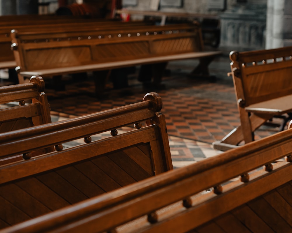 a row of wooden benches sitting next to each other