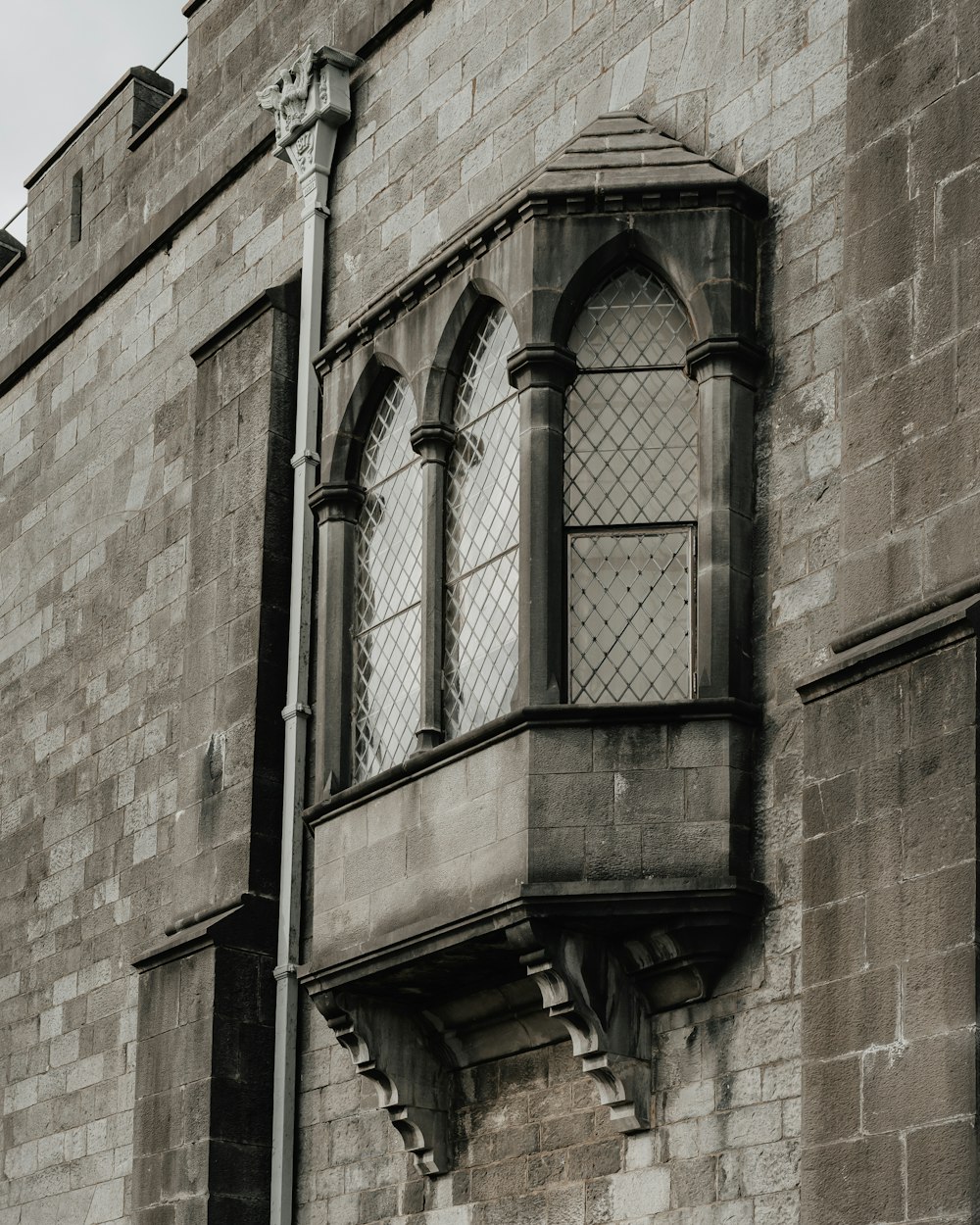 a tall brick building with a window on the side of it