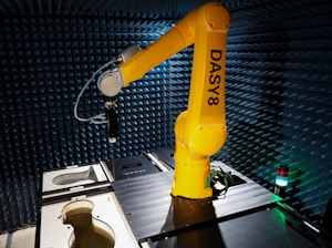 a yellow robot sitting on top of a table