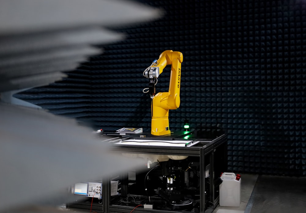 a yellow robot sitting on top of a table