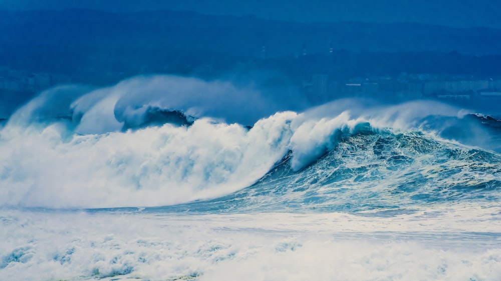 a large wave is breaking over the ocean