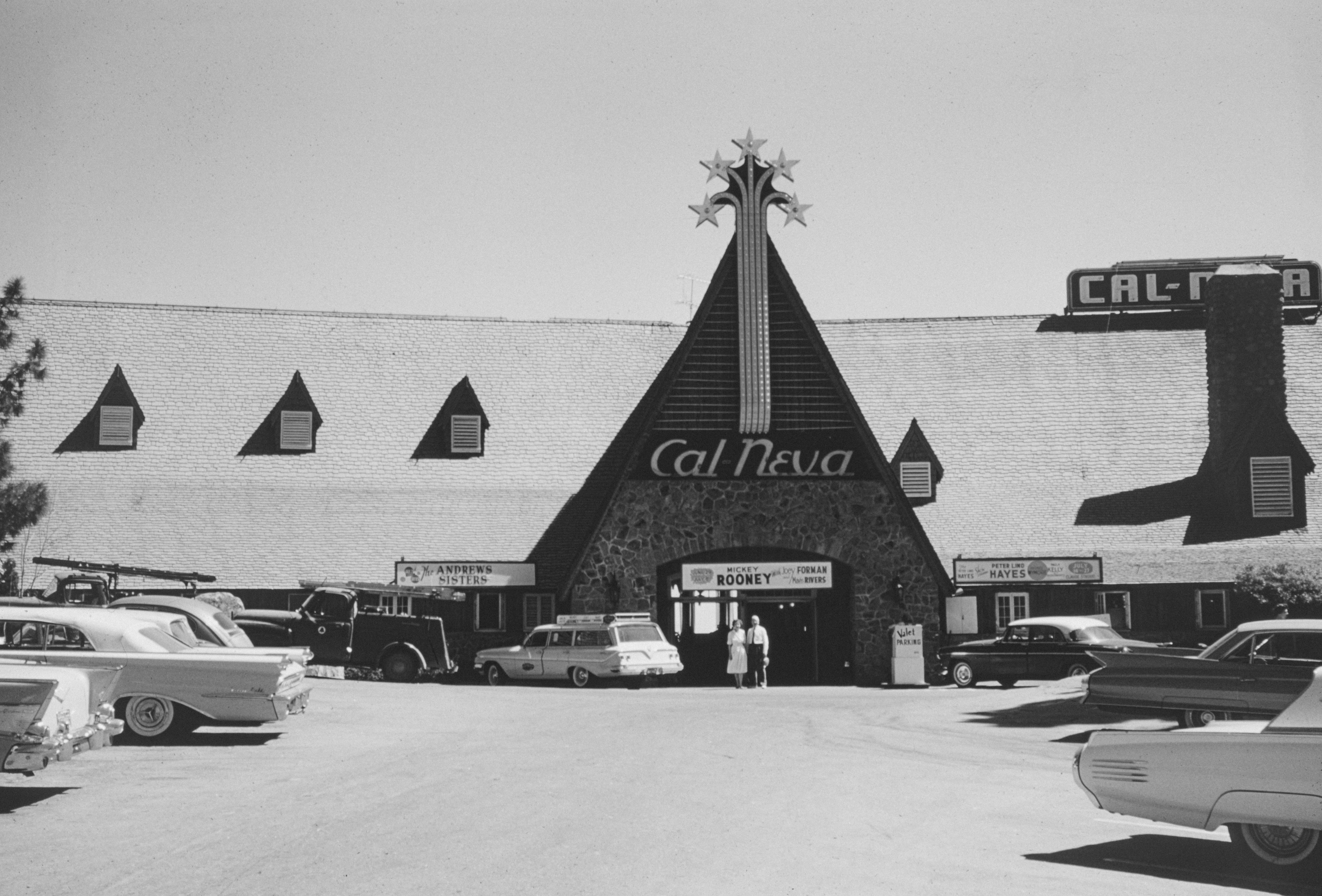 a black and white photo of a car dealership, 