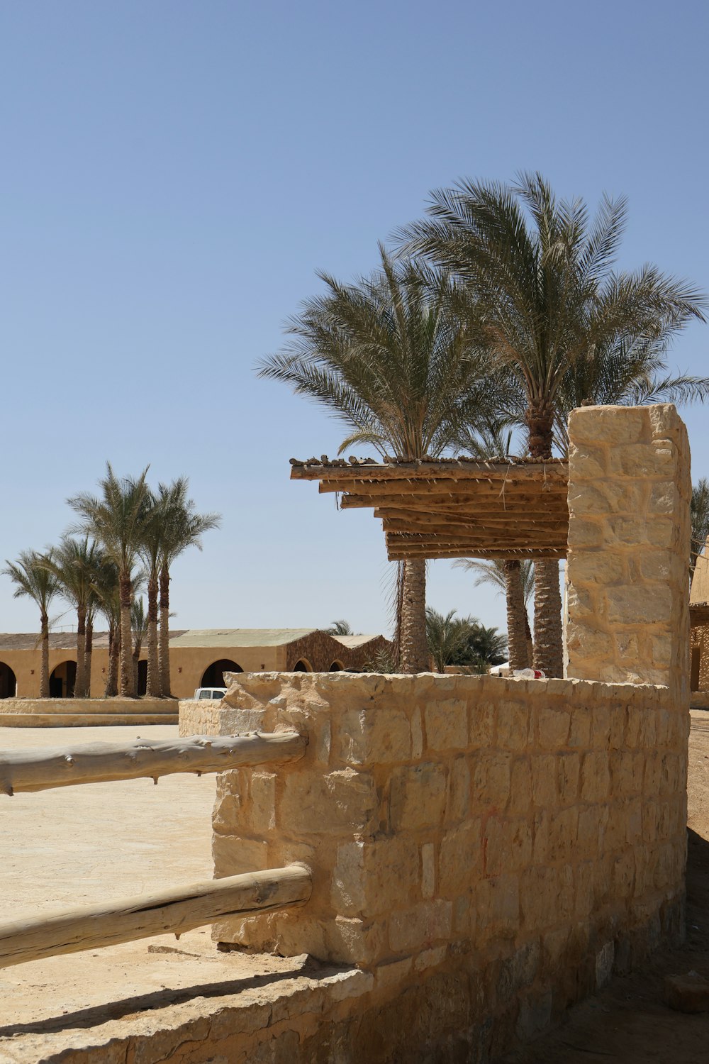 a stone structure with a palm tree in the background
