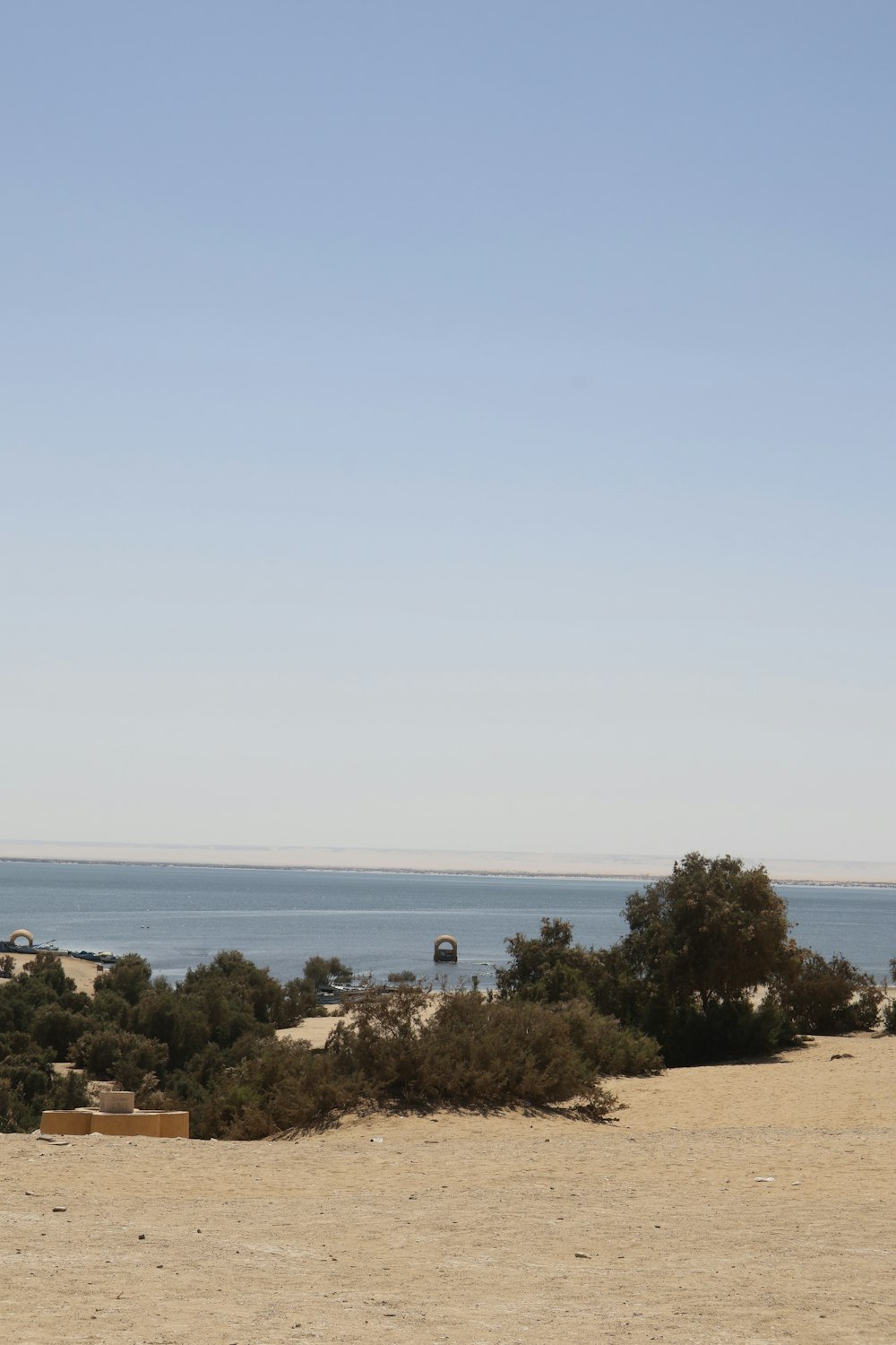 a man riding a horse on top of a sandy beach