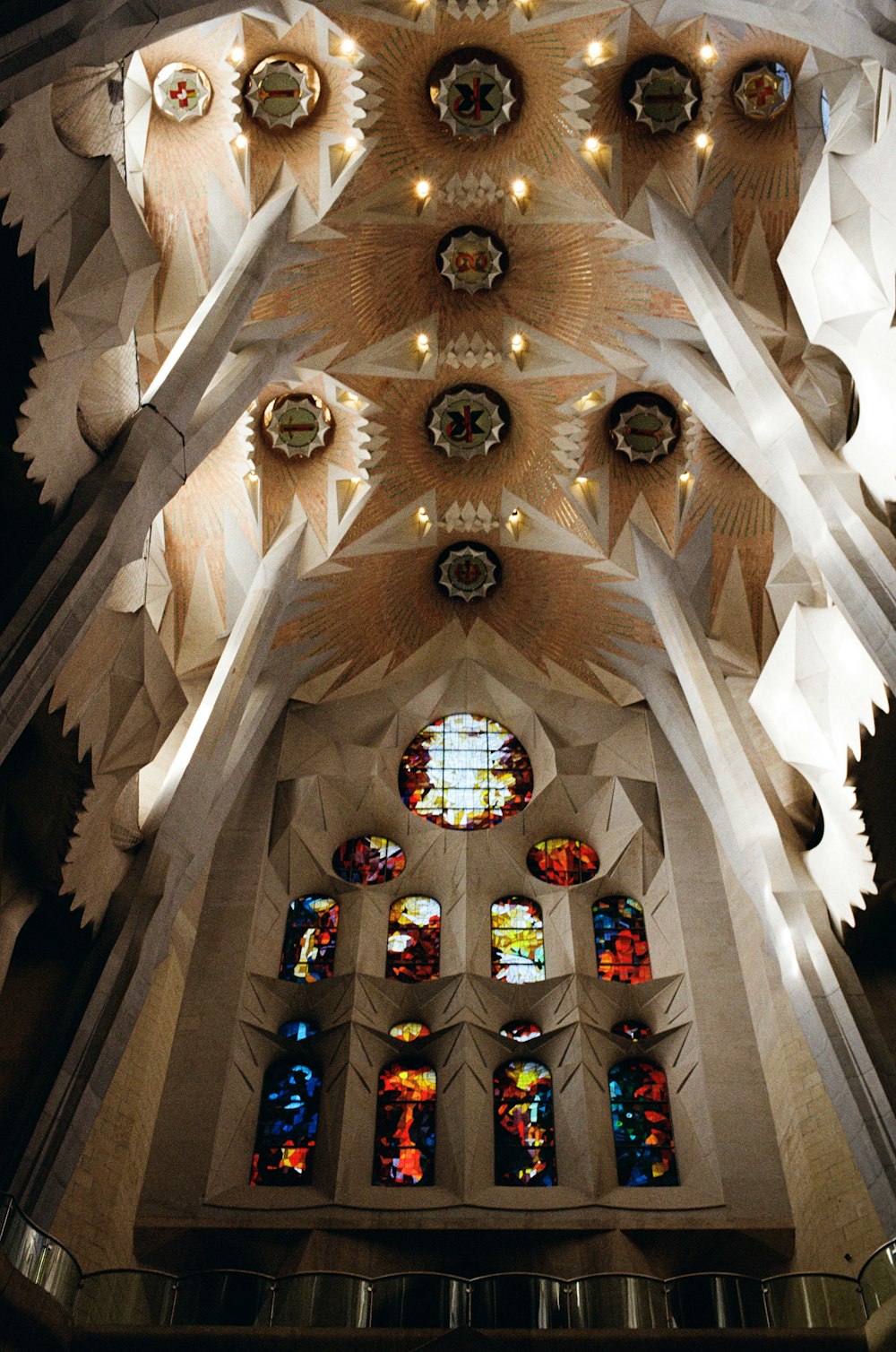 the ceiling of a church with stained glass windows