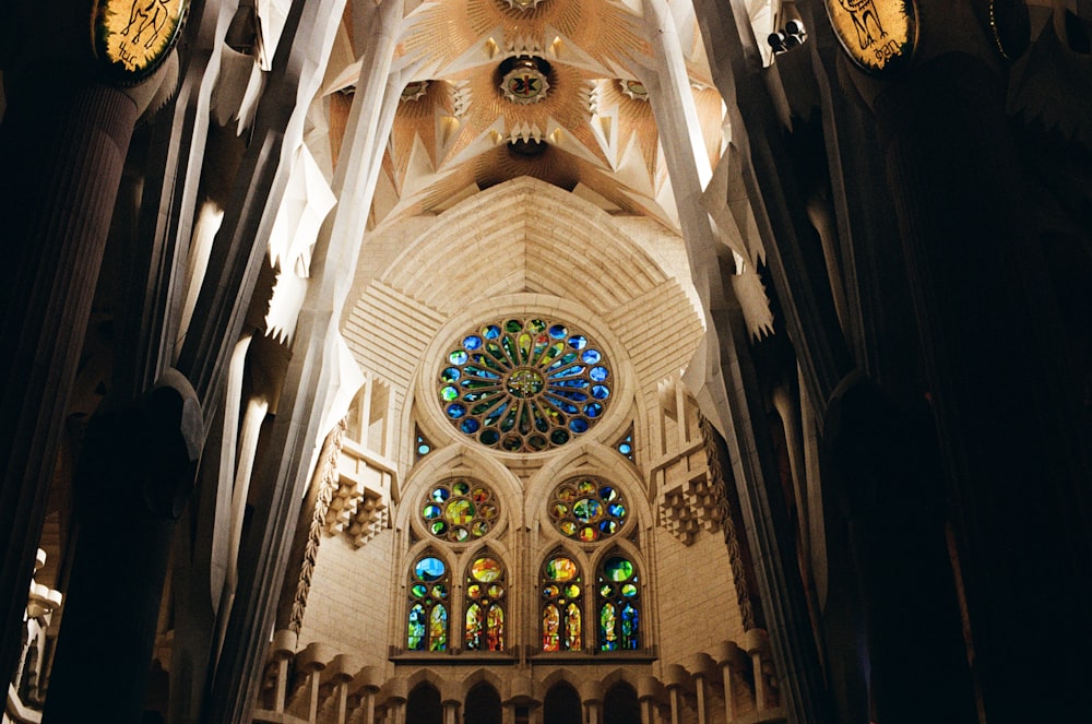 the interior of a cathedral with stained glass windows