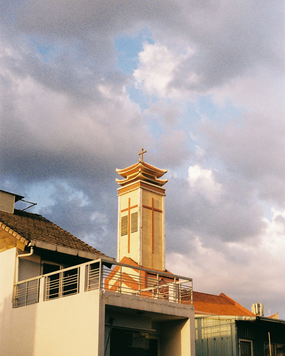 a clock tower on top of a building under a cloudy sky
