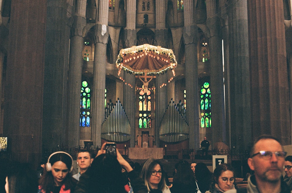 a group of people standing in front of a church organ