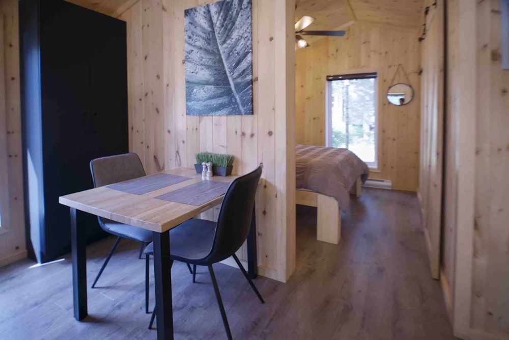 a table and chairs in a room with wood paneling