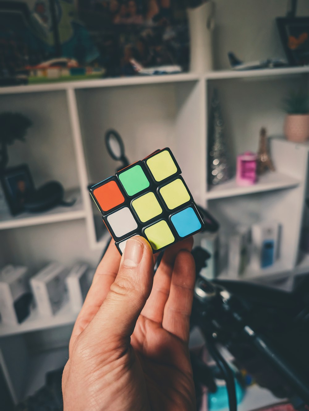 a person holding a rubik cube in their hand