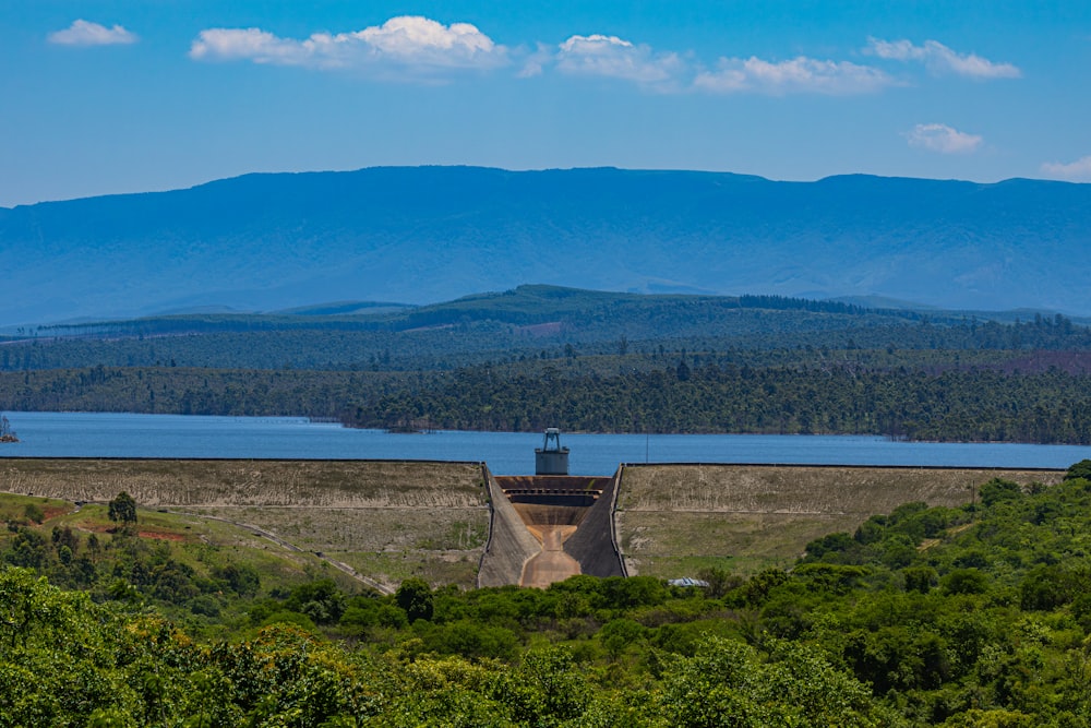 a view of a dam with a lake in the background