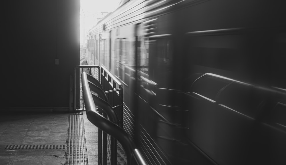 a black and white photo of a train passing by