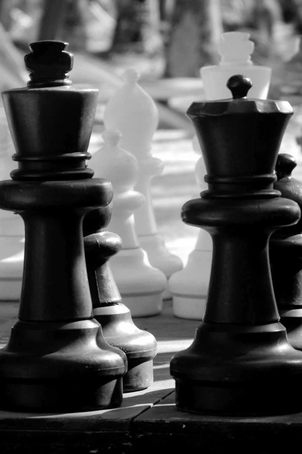 a black and white photo of chess pieces