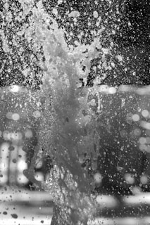 a black and white photo of a water fountain