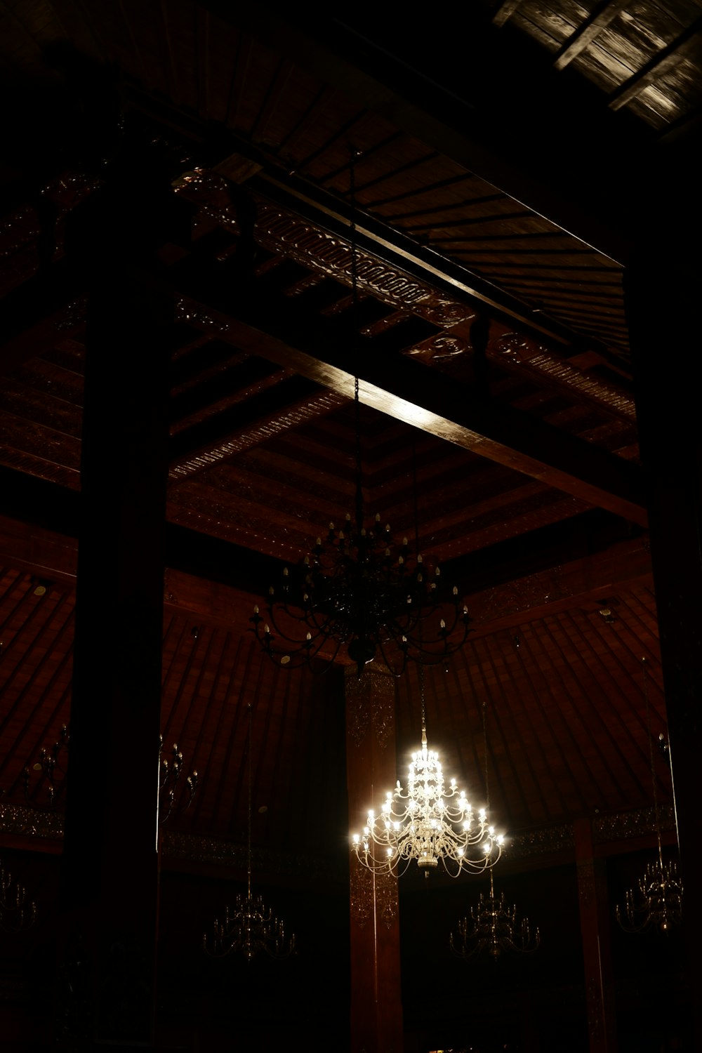 a chandelier hanging from a ceiling in a dark room